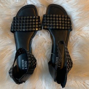 Bleecker & Bond black leather sandals with silver details.